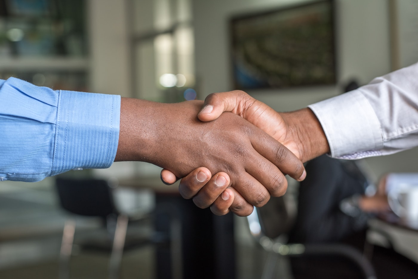 A handshake after a job well done — the moment to ask for a Google review, not a fake testimonial