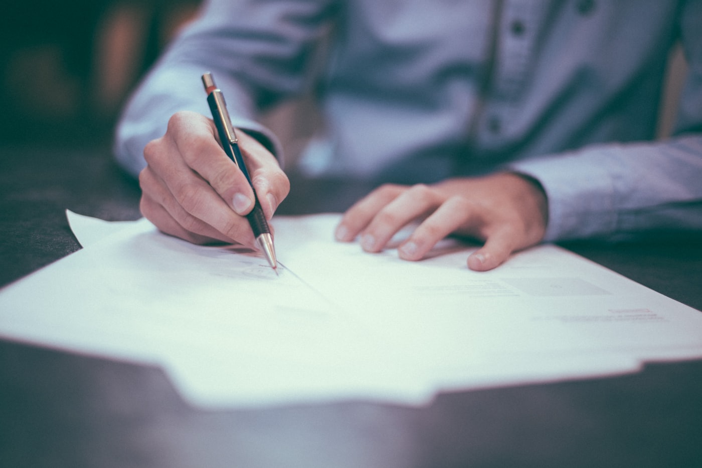 Signed documents on a desk — the kind of personal data a UAE website form collects