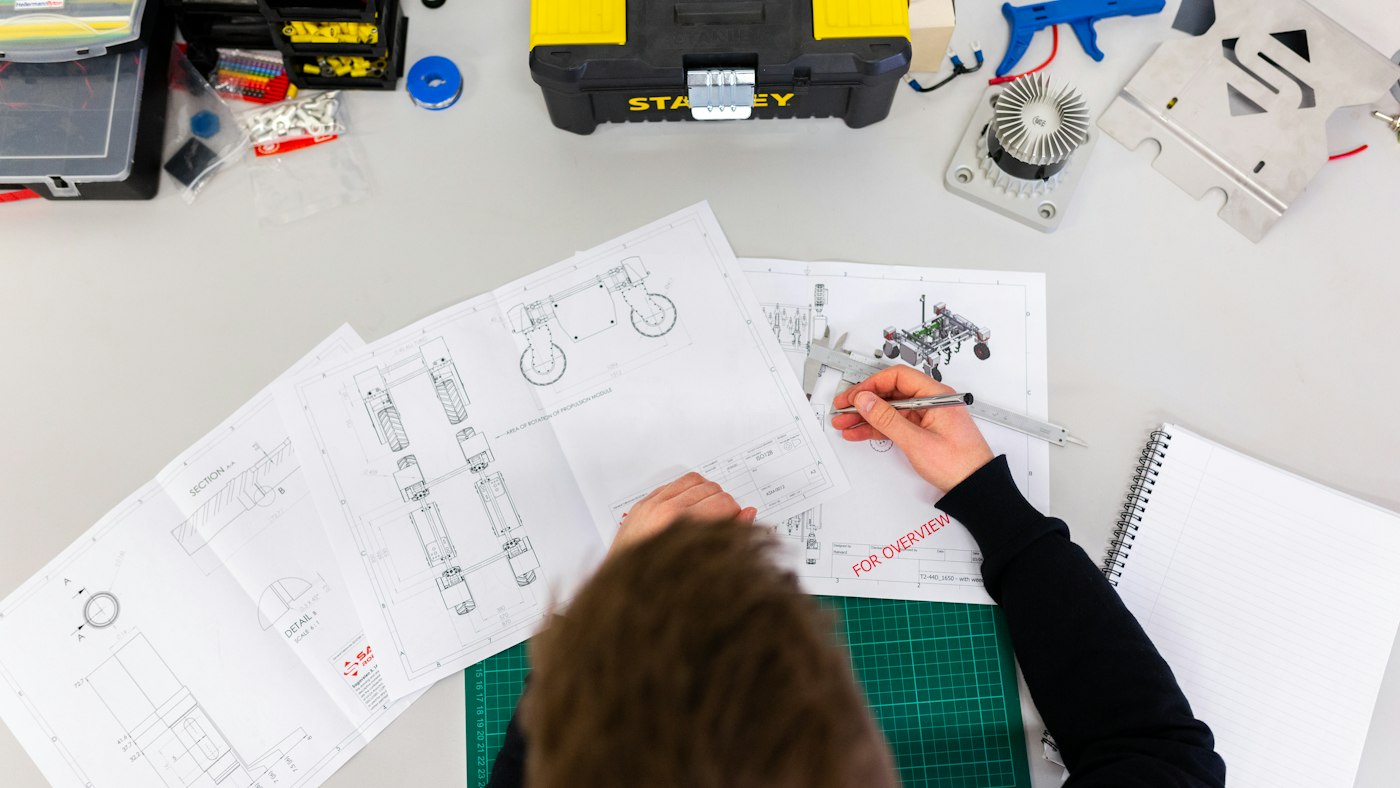 Logo sketches beside a simple website layout, showing branding and web design as related but different jobs