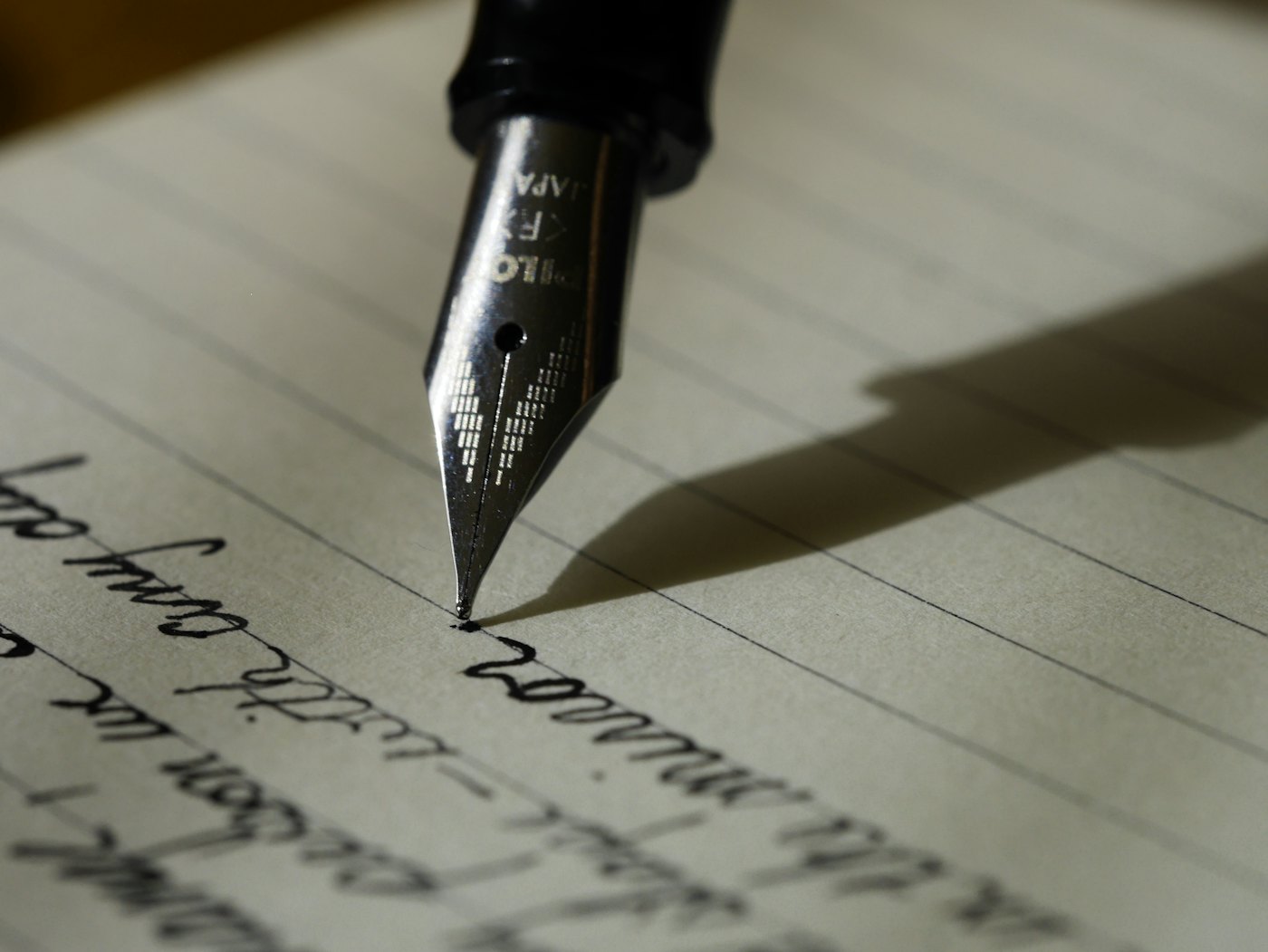 Notebook and pen — website copy starts with sentences a buyer can believe
