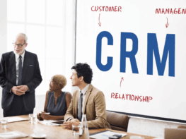 A growing business team analyzing customer data and sales pipelines on a custom CRM dashboard in a modern Dubai office.