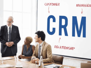 A growing business team analyzing customer data and sales pipelines on a custom CRM dashboard in a modern Dubai office.
